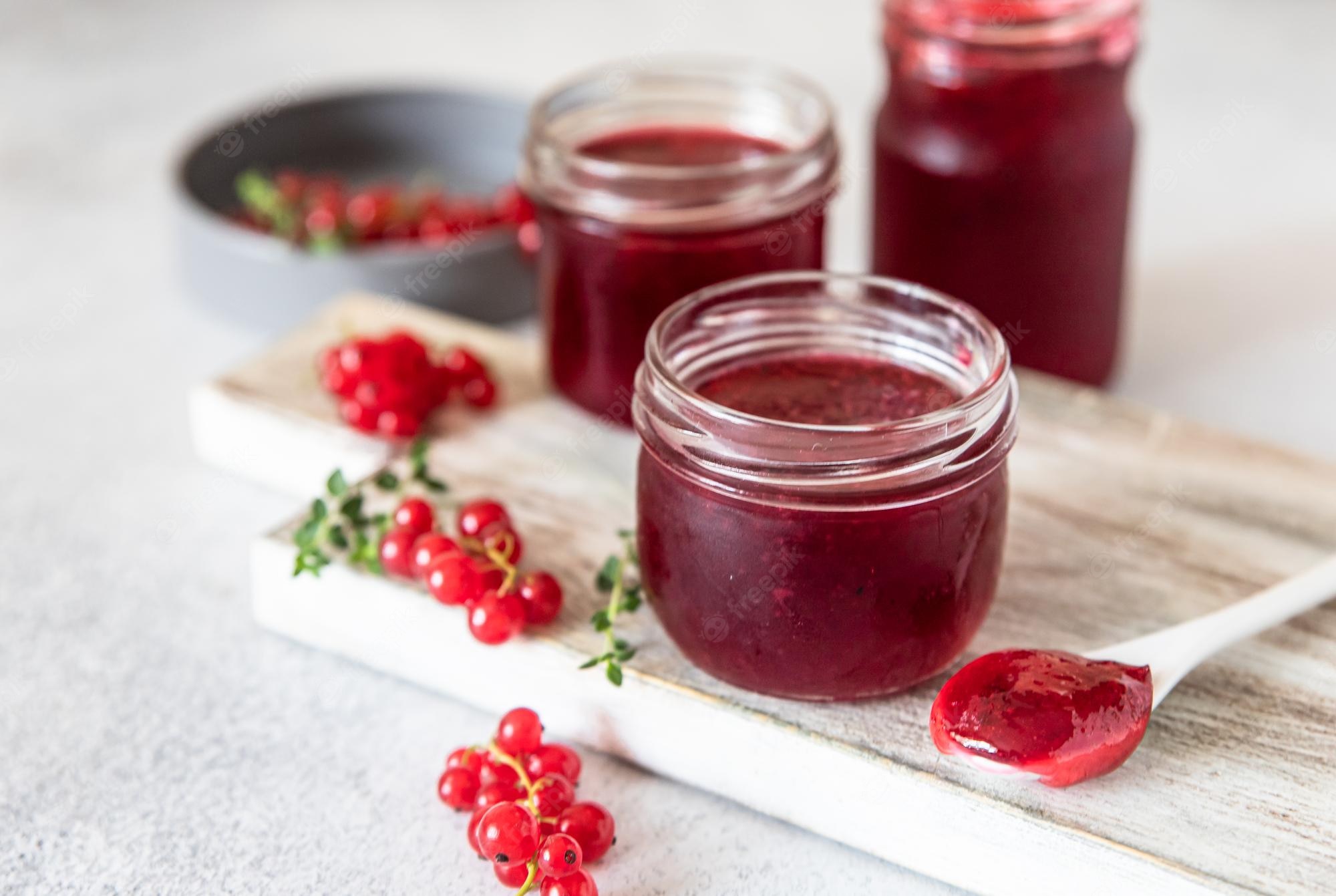 Premium Photo | Homemade red currant jam or jelly in glass jars and red currants berries